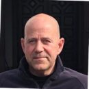 Sorry, I can’t help identify or describe the person in the photo.